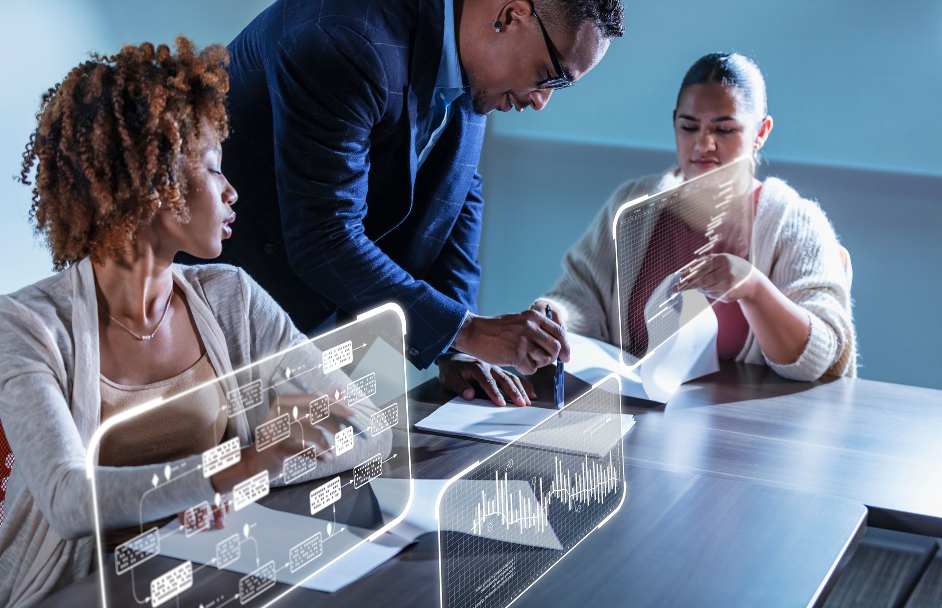 Multiracial business people in meeting reading papers